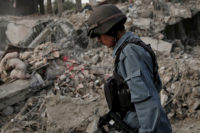Afghan policeman walks at the site a truck bomb blast in Kabul, August 7, 2015. A truck bomb exploded near an army compound in Kabul on Friday, killing at least 15 people and wounding another 248, police and government officials said, in the first major attack in the Afghan capital since the Taliban announced a new leader. REUTERS/Ahmad Masood